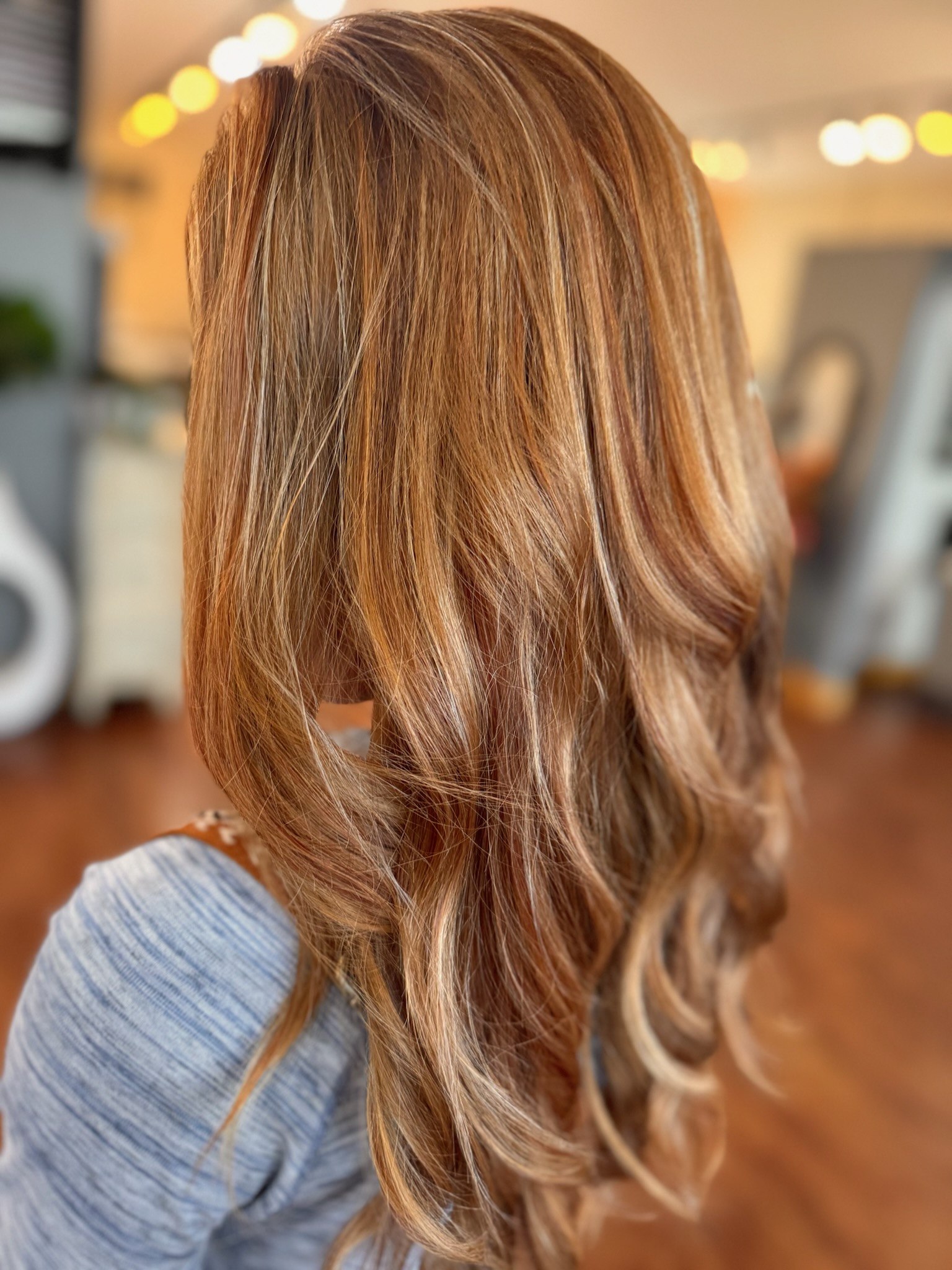 Long honey-blonde hair with extensions and dimensional balayage by Jill George at JN Couture Salon
