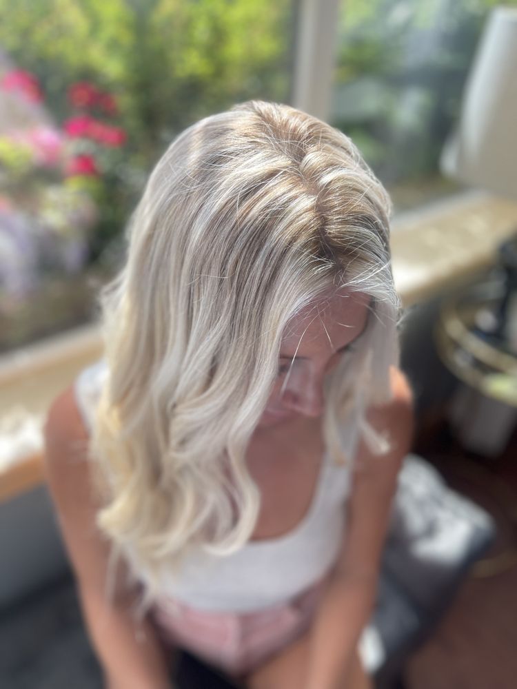 Modern blonde lob styled with soft beach waves