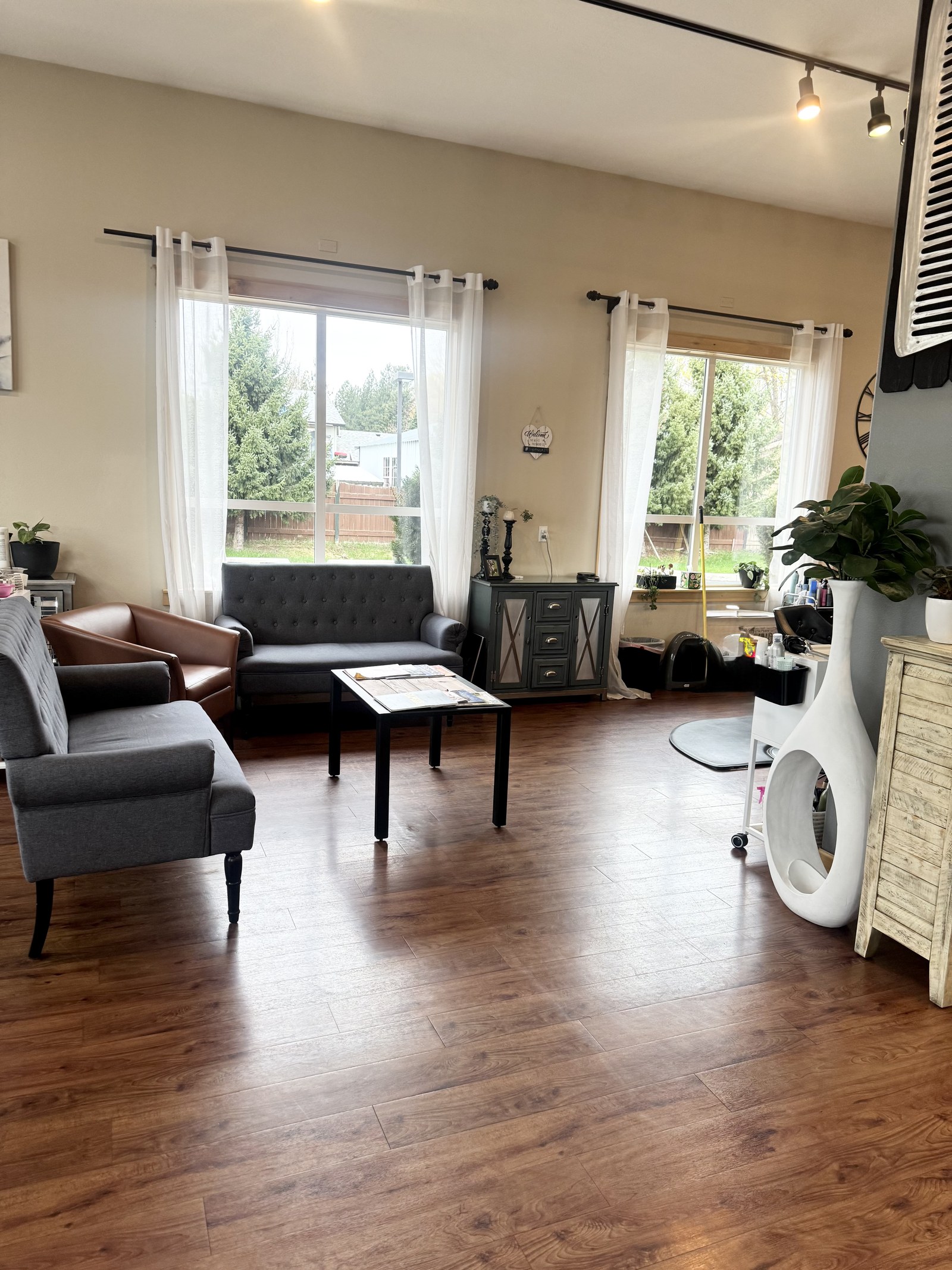 JN Couture seating area with sofas and large windows